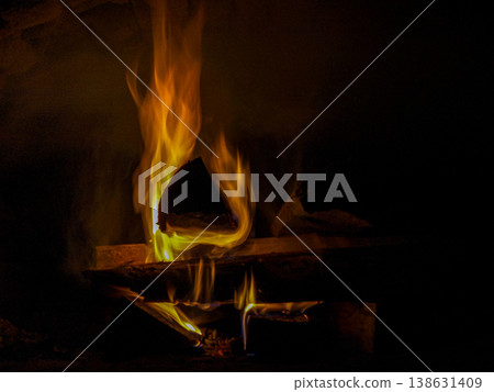 The firewood is burning in the stove 138631409