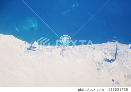 Earth, satellite and landscape, map of desert and Dubai, water and sand in environment, nature and geography. Aerial view, country and terrain, ocean or sea from space with city, island or coastline 138631786