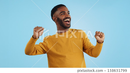 Dance, man and excited for party in studio to celebrate success, promotion and winning lotto on blue background. Happy young model, giveaway winner and energy for disco, groovy music and freedom 138631799