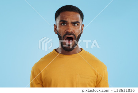 Face, surprise and man with gossip, news and announcement on a blue studio background. Portrait, person and model with shock, expression and mockup space with wow, omg and emoji with secret and icon 138631836
