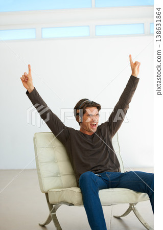 Happy, headphones and young man on a chair listening to music, playlist or radio at home. Excited, scream and male person streaming a song or album for singing karaoke in modern apartment or house. Happy, headphones and young man on a chair listening to music, playlist or radio at home. Excited, scream and male person streaming a song or album for singing karaoke in modern apartment or house. 138631864
