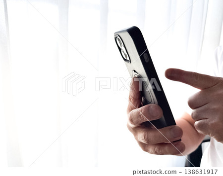 Hands for operating a smartphone Hands for operating a smartphone 138631917