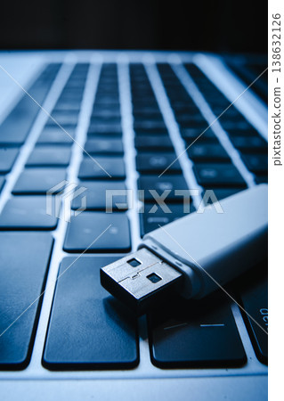 USB flash drive lying on a laptop keyboard as a concept of cyber security and digital data protection USB flash drive lying on a laptop keyboard as a concept of cyber security and digital data protection 138632126
