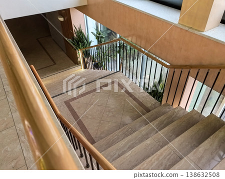 View looking down a marble staircase in a modern building lobby. View looking down a marble staircase in a modern building lobby. 138632508