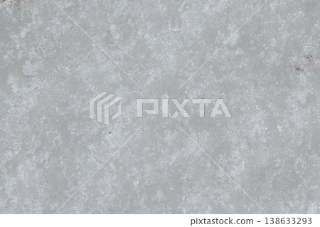 Snow Texture Close-Up. White Winter Snow Surface with Crystalline Pattern and Frost Details. Macro close-up view of natural snow texture showing detailed crystalline structure and frost patterns on wh Snow Texture Close-Up. White Winter Snow Surface with Crystalline Pattern and Frost Details. Macro close-up view of natural snow texture showing detailed crystalline structure and frost patterns on wh 138633293