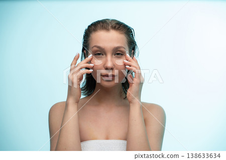 Woman applying under eye patches, creating a refreshing skincare routine, nurturing her face with cosmetic treatment for beauty and wellness 138633634
