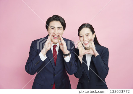 Businessmen and businesswomen cheering on the camera, looking directly at the camera. Businessmen and businesswomen cheering on the camera, looking directly at the camera. 138633772