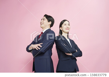 Portraits of a businessman and businesswoman against a pink background. Portraits of a businessman and businesswoman against a pink background. 138633779