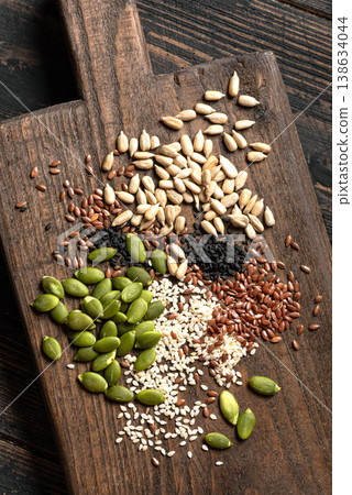 Mix of seeds on wooden board Mix of seeds on wooden board 138634044