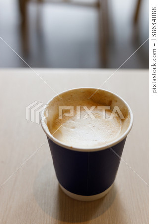Cup of hot milk latte coffee on table by the window. 138634088