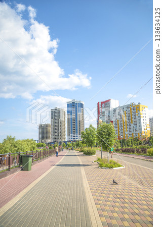 Pedestrian area with footpath in a city by sunny summer day Pedestrian area with footpath in a city by sunny summer day 138634125