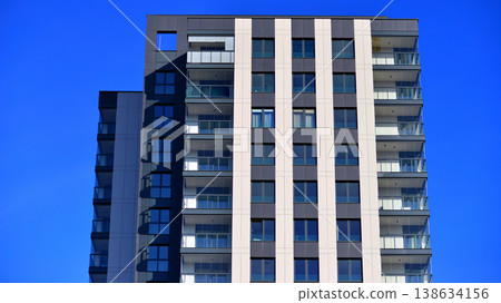 Exterior of a high modern multi-story apartment building - facade, windows and balconies. Exterior of a high modern multi-story apartment building - facade, windows and balconies. 138634156