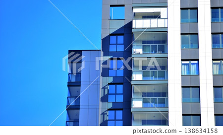 Exterior of a high modern multi-story apartment building - facade, windows and balconies. 138634158