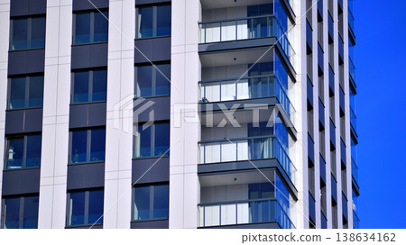 Exterior of a high modern multi-story apartment building - facade, windows and balconies. 138634162