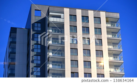 Exterior of a high modern multi-story apartment building - facade, windows and balconies. Exterior of a high modern multi-story apartment building - facade, windows and balconies. 138634164