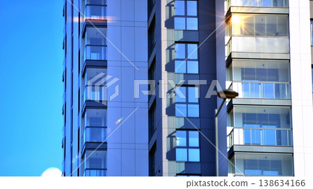 Exterior of a high modern multi-story apartment building - facade, windows and balconies. 138634166