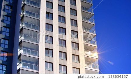 Exterior of a high modern multi-story apartment building - facade, windows and balconies. 138634167