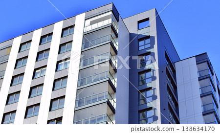 Exterior of a high modern multi-story apartment building - facade, windows and balconies. Exterior of a high modern multi-story apartment building - facade, windows and balconies. 138634170