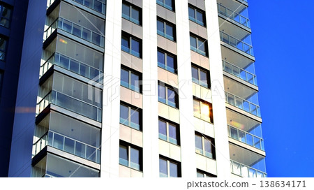 Exterior of a high modern multi-story apartment building - facade, windows and balconies. 138634171