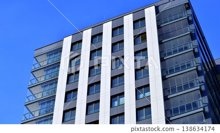 Exterior of a high modern multi-story apartment building - facade, windows and balconies. 138634174