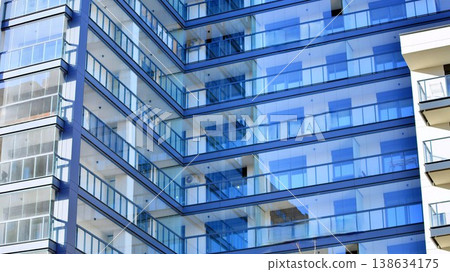 Exterior of a high modern multi-story apartment building - facade, windows and balconies. Exterior of a high modern multi-story apartment building - facade, windows and balconies. 138634175
