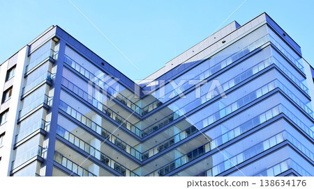 Exterior of a high modern multi-story apartment building - facade, windows and balconies. Exterior of a high modern multi-story apartment building - facade, windows and balconies. 138634176