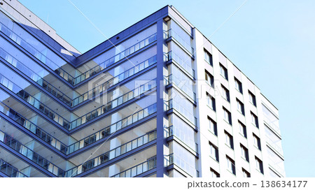 Exterior of a high modern multi-story apartment building - facade, windows and balconies. Exterior of a high modern multi-story apartment building - facade, windows and balconies. 138634177