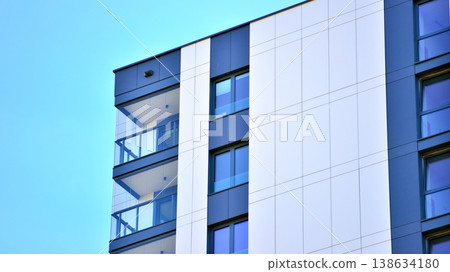 Exterior of a high modern multi-story apartment building - facade, windows and balconies. Exterior of a high modern multi-story apartment building - facade, windows and balconies. 138634180