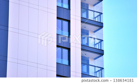 Exterior of a high modern multi-story apartment building - facade, windows and balconies. Exterior of a high modern multi-story apartment building - facade, windows and balconies. 138634181