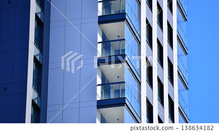Exterior of a high modern multi-story apartment building - facade, windows and balconies. 138634182