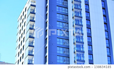 Exterior of a high modern multi-story apartment building - facade, windows and balconies. 138634185