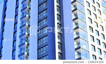 Exterior of a high modern multi-story apartment building - facade, windows and balconies. Exterior of a high modern multi-story apartment building - facade, windows and balconies. 138634189
