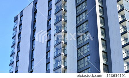 Exterior of a high modern multi-story apartment building - facade, windows and balconies. Exterior of a high modern multi-story apartment building - facade, windows and balconies. 138634191
