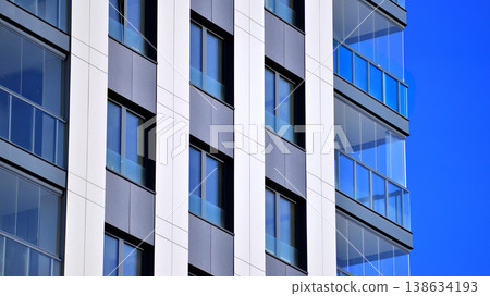 Exterior of a high modern multi-story apartment building - facade, windows and balconies. 138634193