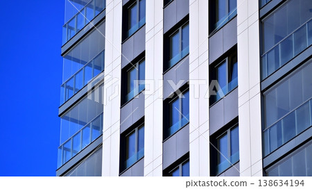 Exterior of a high modern multi-story apartment building - facade, windows and balconies. Exterior of a high modern multi-story apartment building - facade, windows and balconies. 138634194