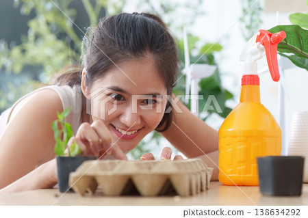 Woman nurturing seedlings with care indoors 138634292