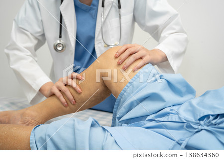 Doctor checking Asian elderly woman patient with scar knee replacement surgery in hospital. Doctor checking Asian elderly woman patient with scar knee replacement surgery in hospital. 138634360