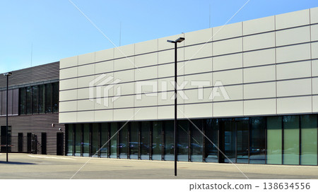 Empty new constructed automobile dealership. The building contains a sales room, offices, service and parts warehouse. Empty new constructed automobile dealership. The building contains a sales room, offices, service and parts warehouse. 138634556