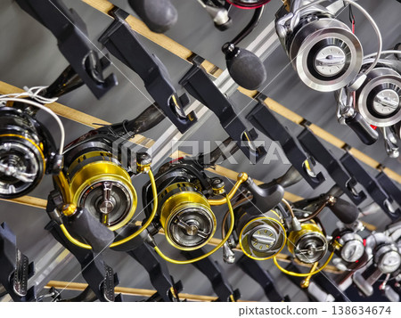 Fishing reels display in a retail store for anglers looking to buy equipment during a busy weekend afternoon Fishing reels display in a retail store for anglers looking to buy equipment during a busy weekend afternoon 138634674