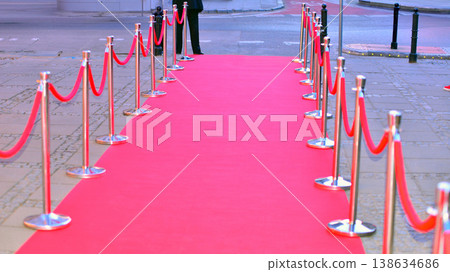 Long red carpet between rope barriers on entrance. 138634686