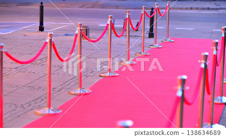 Long red carpet between rope barriers on entrance. Long red carpet between rope barriers on entrance. 138634689