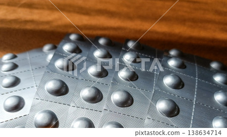 Five New Blister Packs Arranged in Fan Shape on Wooden Table Five New Blister Packs Arranged in Fan Shape on Wooden Table 138634714