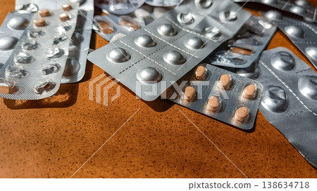 Used Medicine Blister Packs on Wooden Table with Copy Space Used Medicine Blister Packs on Wooden Table with Copy Space 138634718