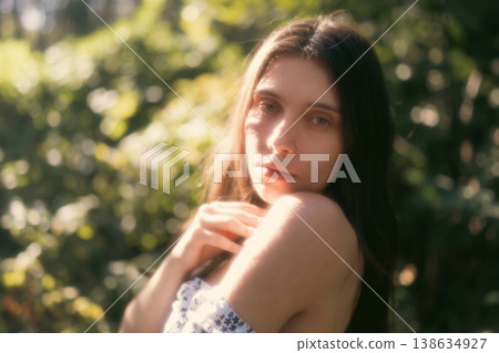 Soft portrait of young woman in warm woodland light Soft portrait of young woman in warm woodland light 138634927