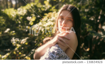 Dreamy portrait of young woman in warm forest light Dreamy portrait of young woman in warm forest light 138634928