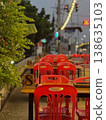 The vacancy chairs and tables at the food street shop with blurred traffic lights in background. 138635103