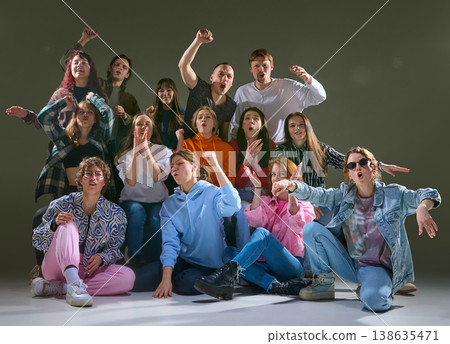 Group of friends reacting with loud emotions and gestures in expressive studio scene. Group of friends reacting with loud emotions and gestures in expressive studio scene. 138635471