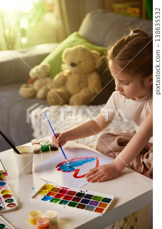 Close up of little girl painting with watercolor brush and colorful palette. 138635532