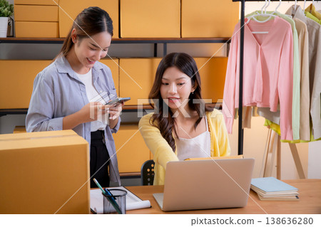 Two asian woman working in small business online store, online seller. Two asian woman working in small business online store, online seller. 138636280