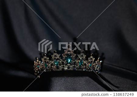 Luxury Crown with Green and Black Crystals on Black Background. Luxury Crown with Green and Black Crystals on Black Background. 138637249